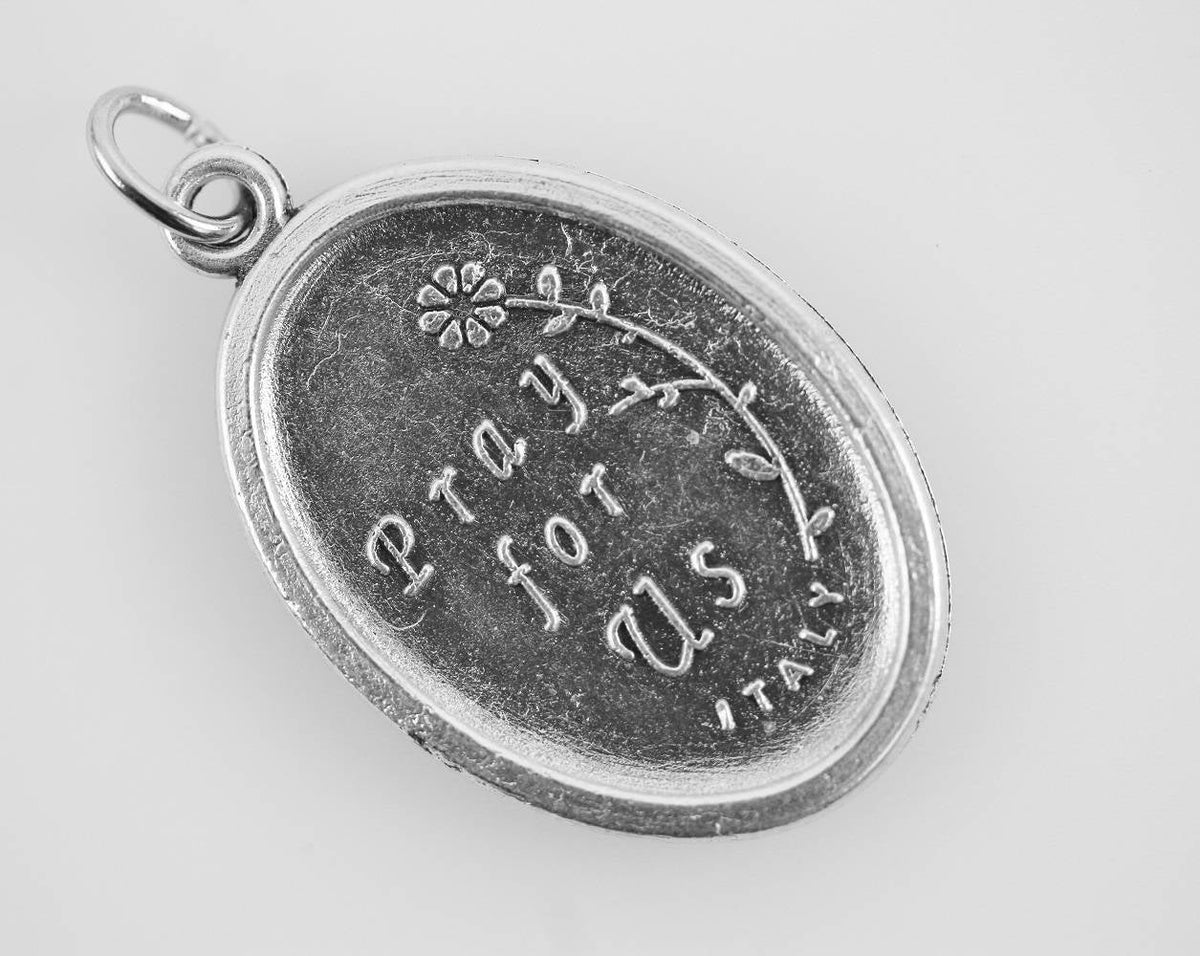 die cast silver medal inscribed with pray for us