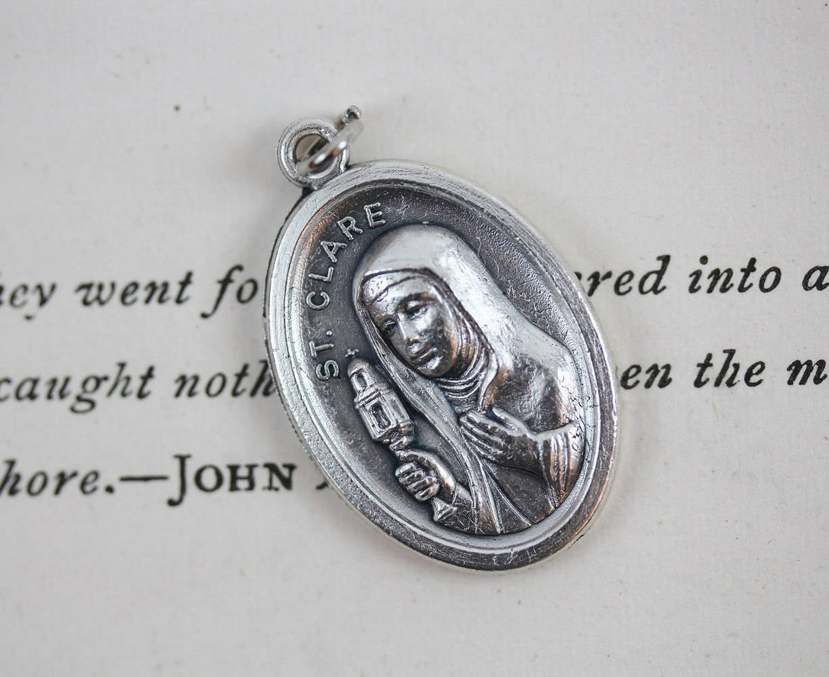 die cast silver saint clare one inch oval medal