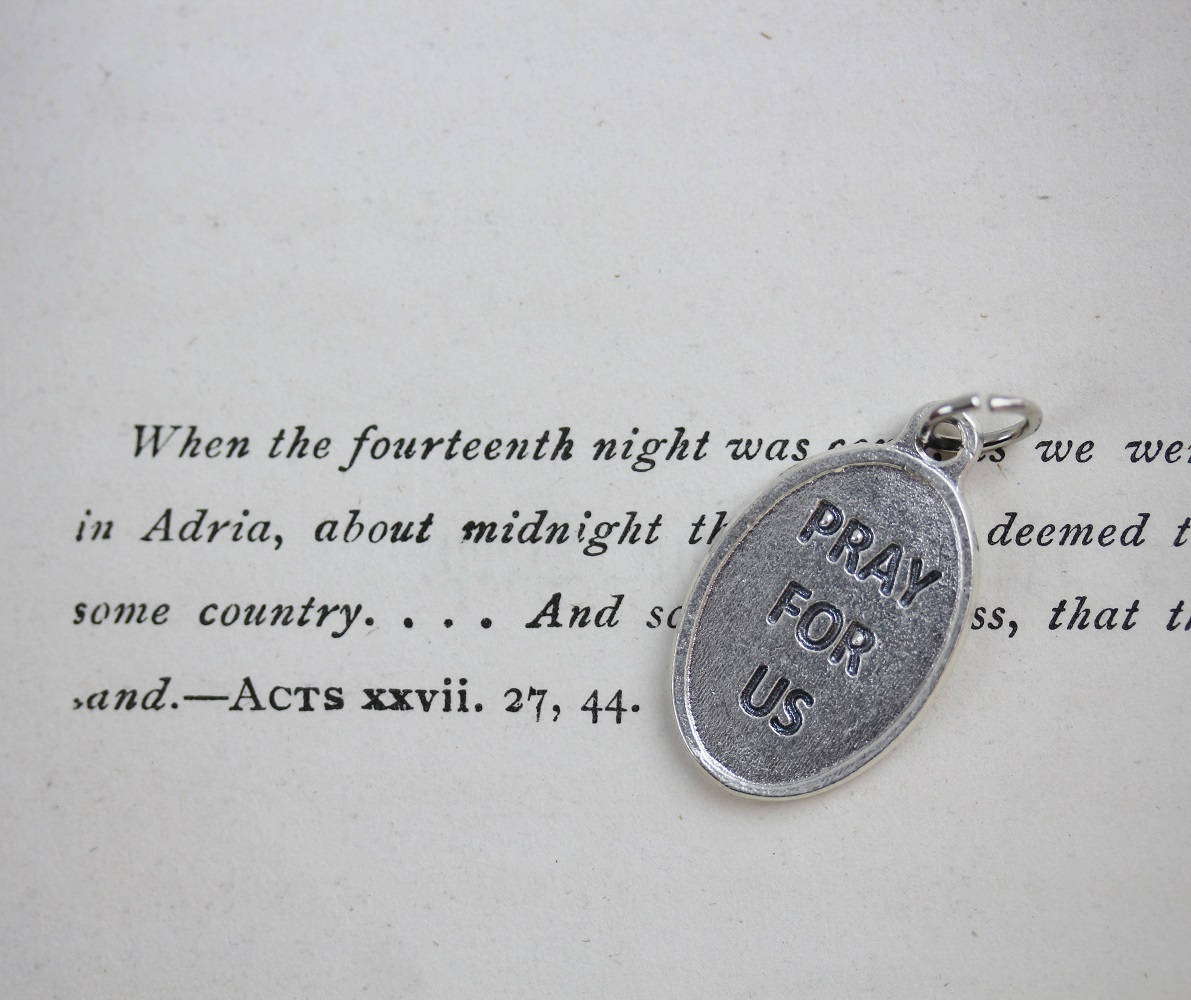 die cast silver medal inscribed with pray for us