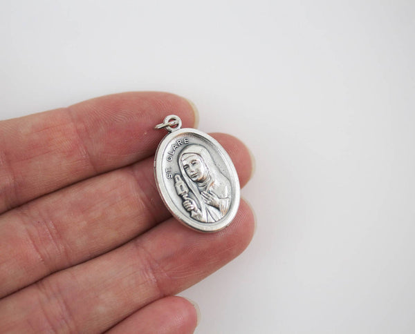 die cast silver saint clare one inch oval medal