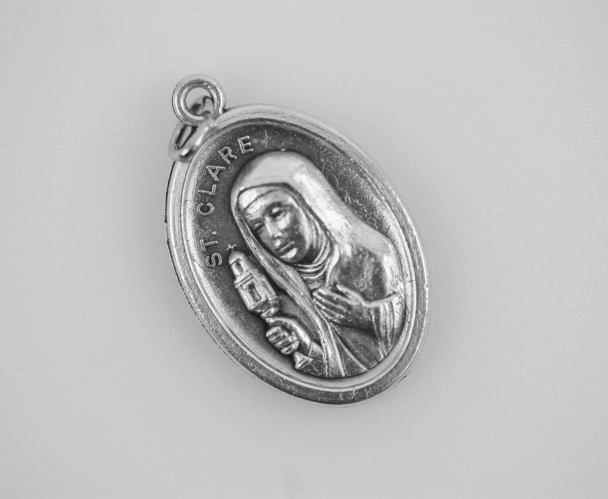 die cast silver saint clare one inch oval medal