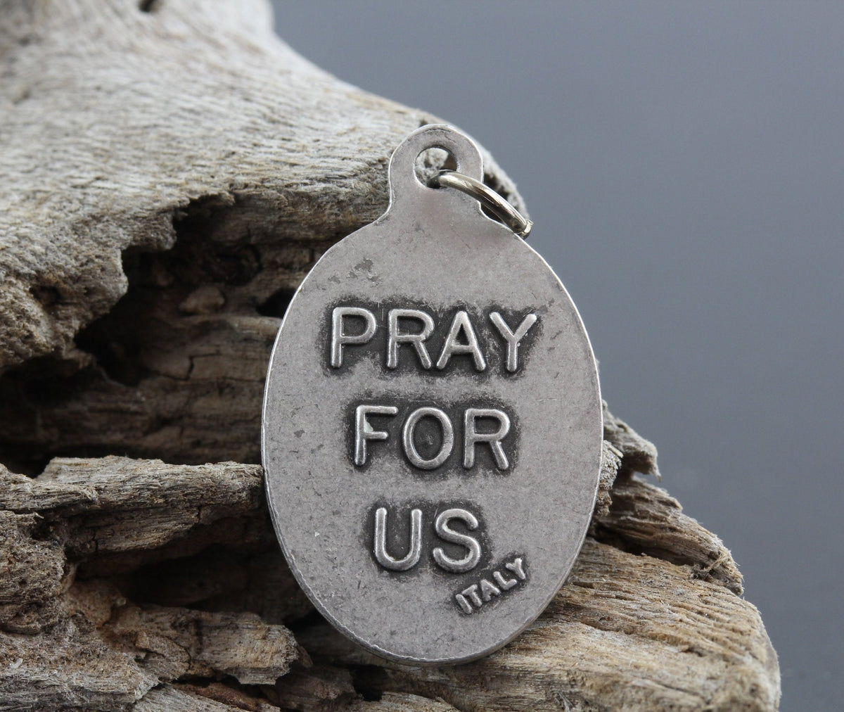 die cast silver medal inscribed with pray for us