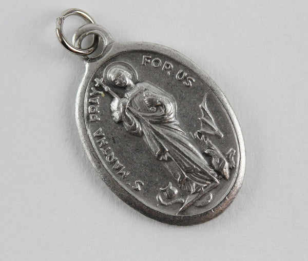die cast silver medal depicting patron saint martha