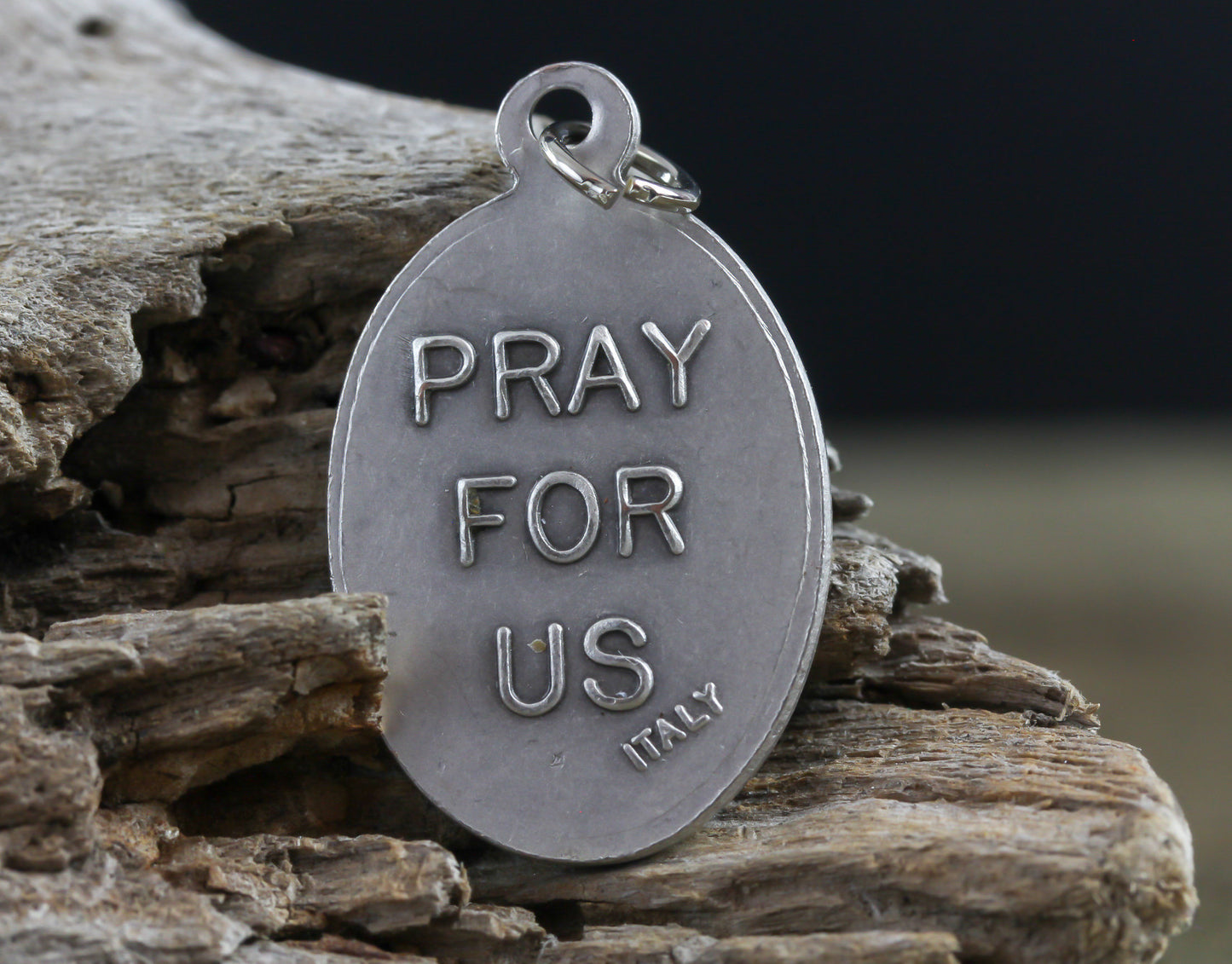 die cast silver medal inscribed with pray for us