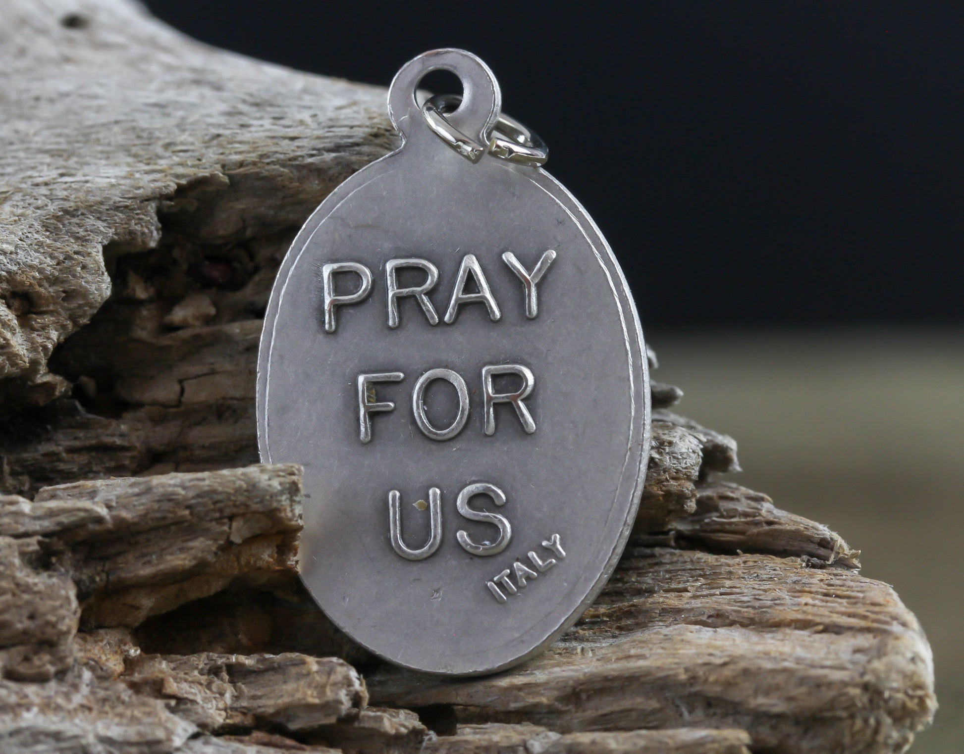 die cast silver medal inscribed with pray for us