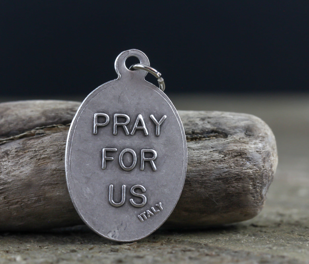 die cast silver medal inscribed with pray for us