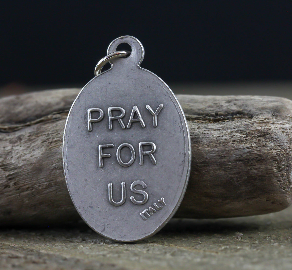 die cast silver medal inscribed with pray for us