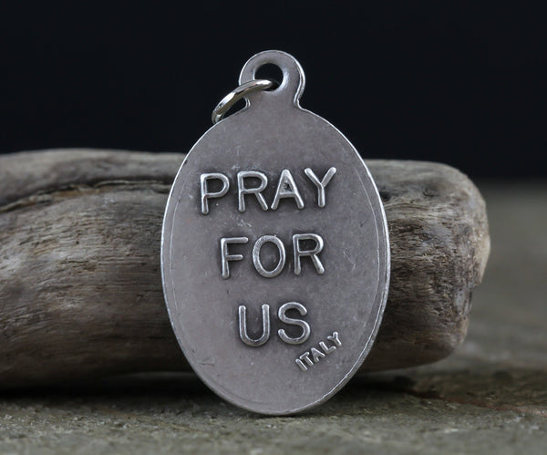 die cast silver medal inscribed with pray for us