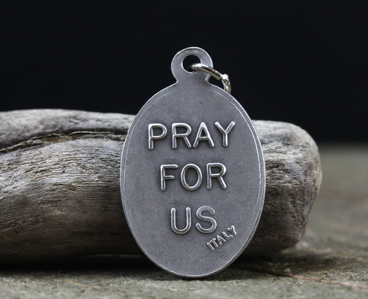 die cast silver medal inscribed with pray for us