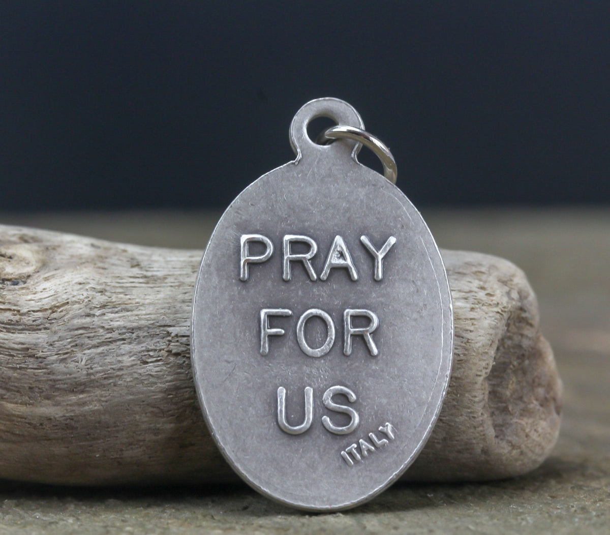 die cast silver medal inscribed with pray for us