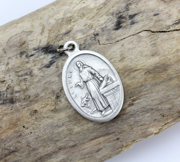die cast silver medal depicting patron saint luke