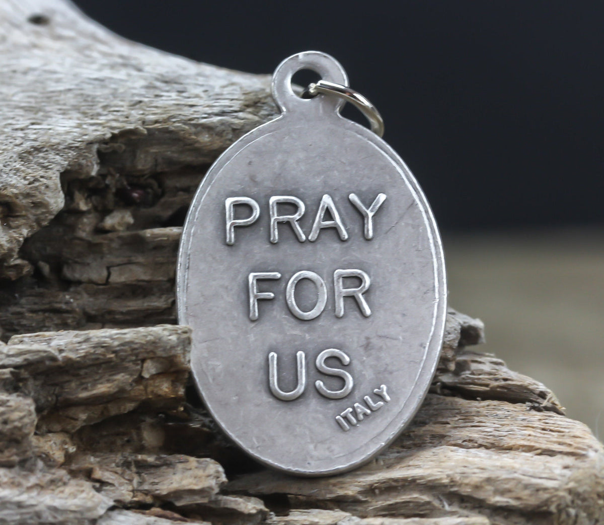 die cast silver medal inscribed with pray for us