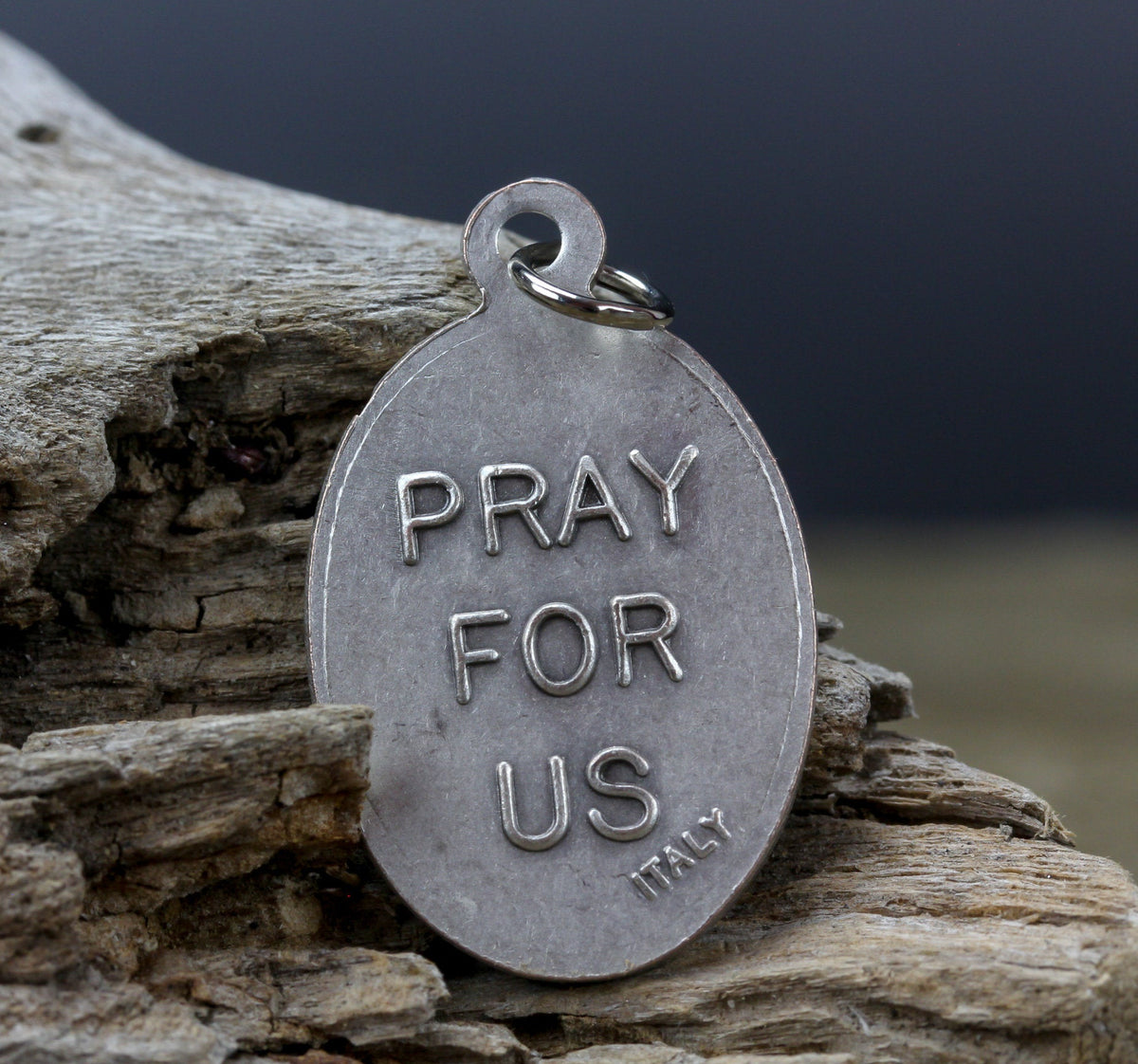 die cast silver medal inscribed with pray for us