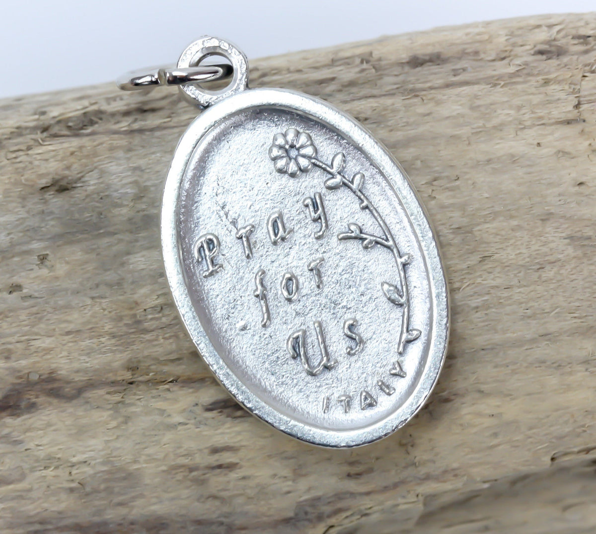 die cast silver medal inscribed with pray for us