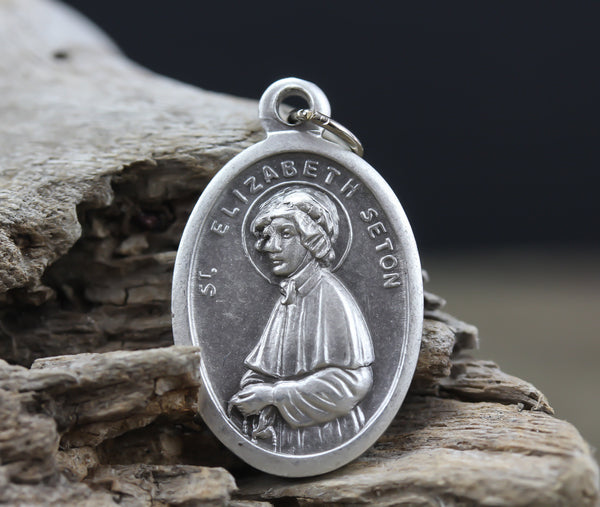 die cast silver medal depicting patron saint elizabeth ann seton