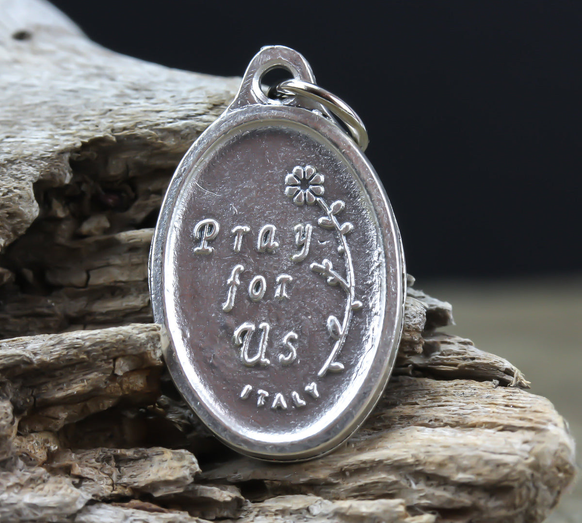 die cast silver medal inscribed with pray for us