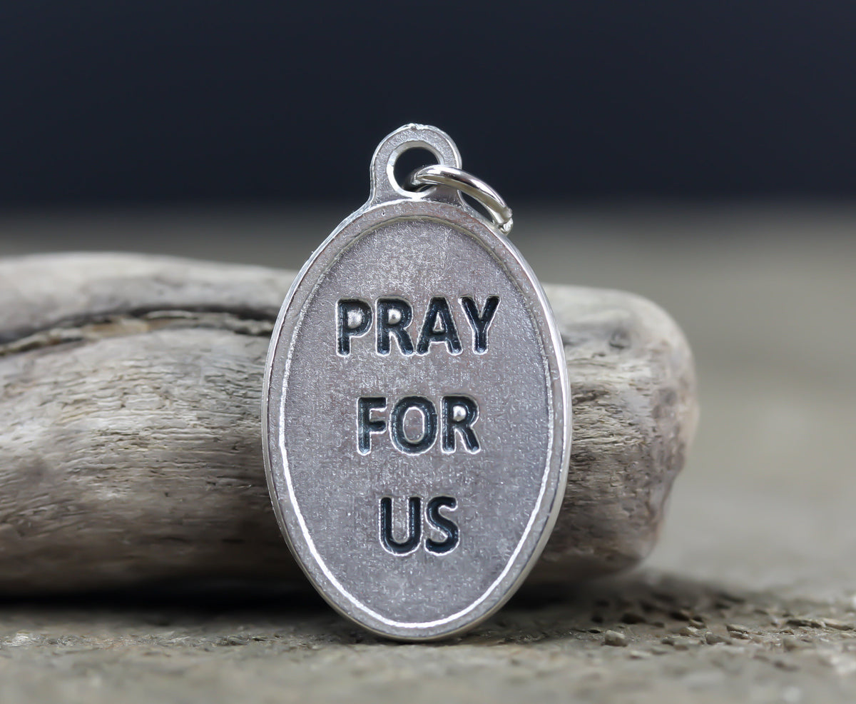die cast silver medal inscribed with pray for us