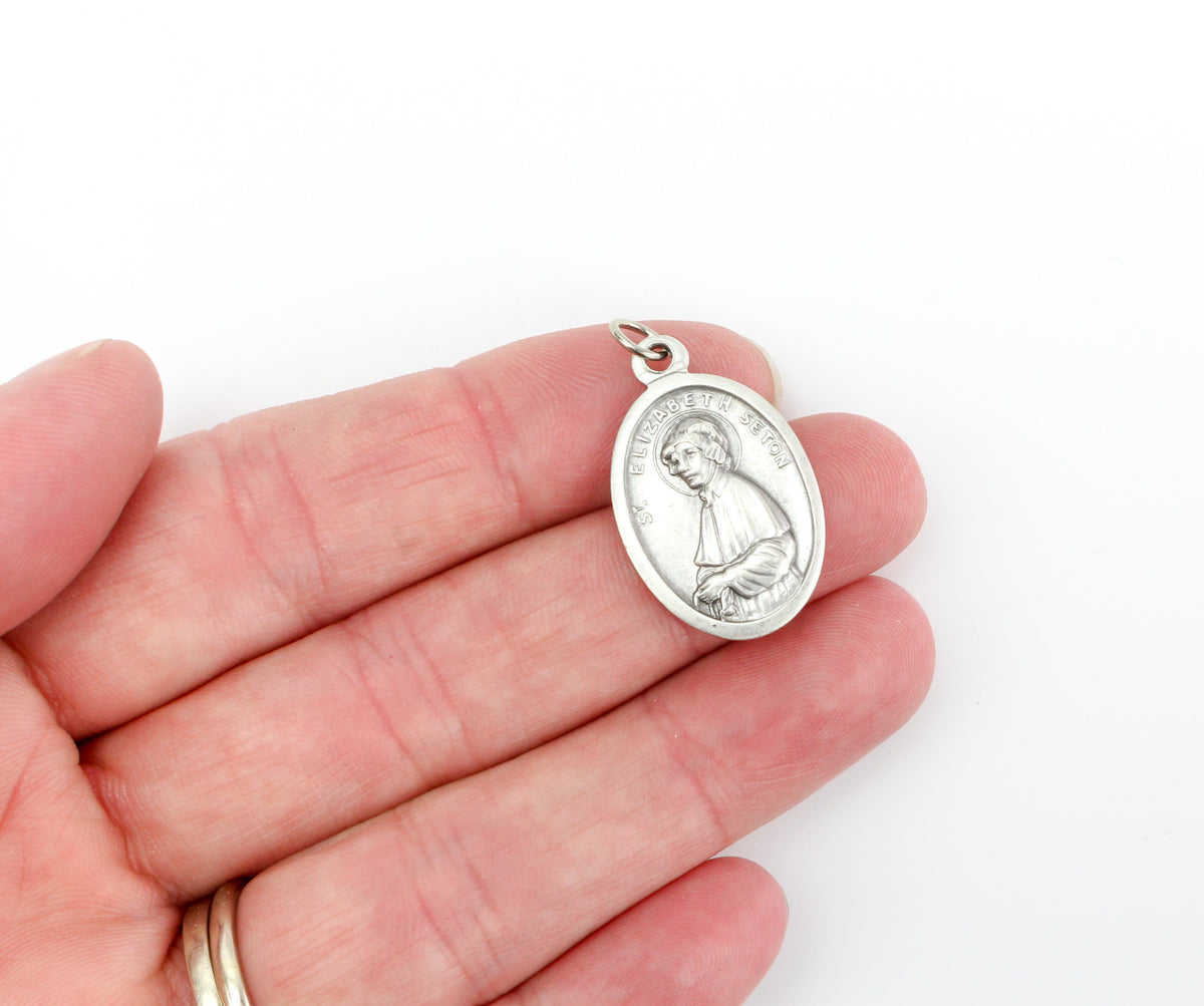 die cast silver medal depicting patron saint elizabeth ann seton