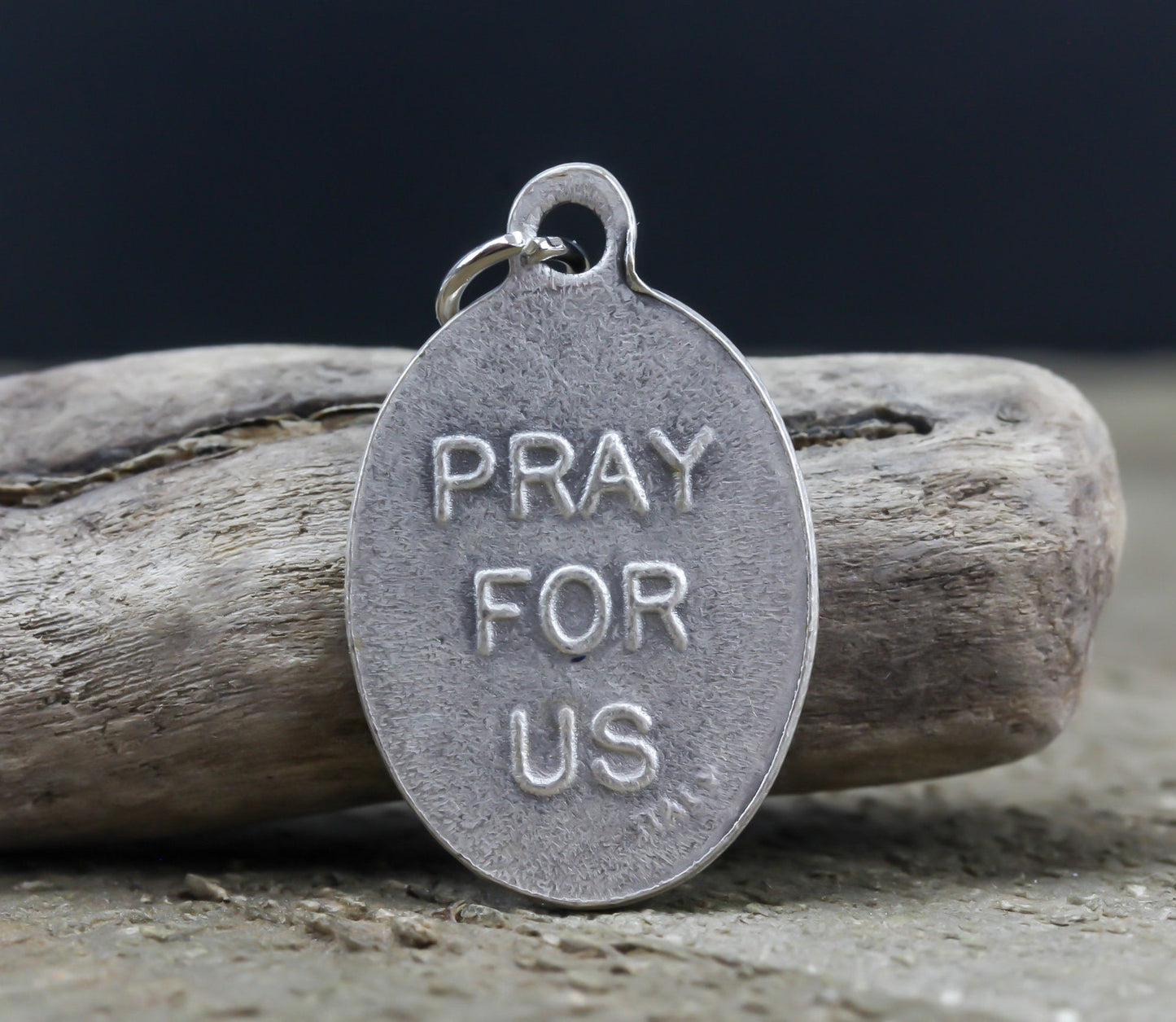 die cast silver medal inscribed with pray for us