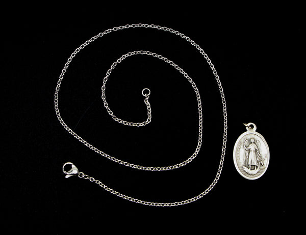 Stainless steel link cable chain necklace next to charm