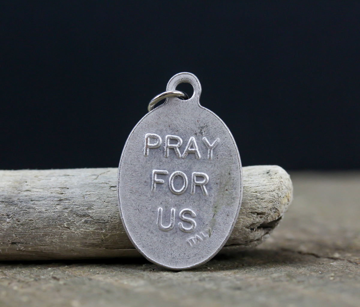 die cast silver medal inscribed with pray for us