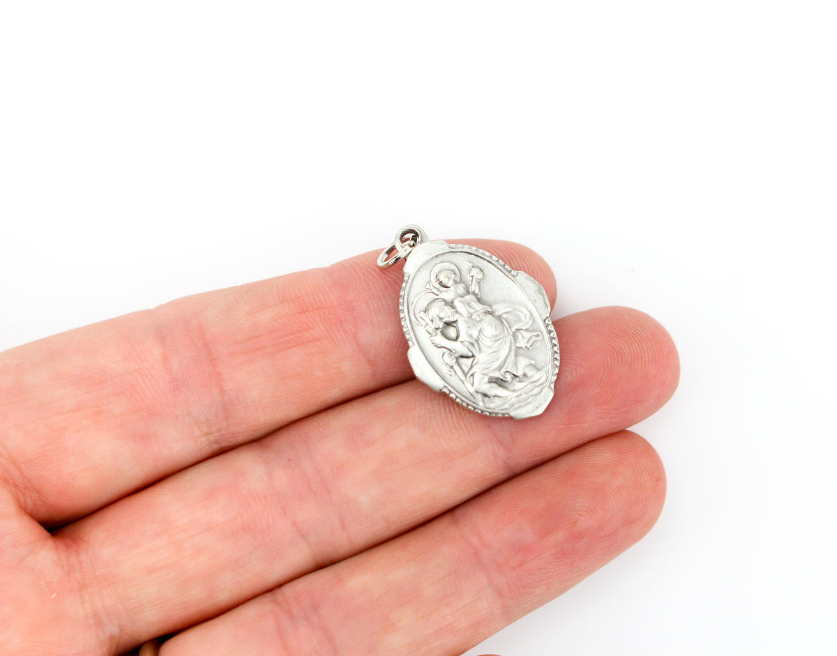 silver saint christopher medal one inch oval ornate border