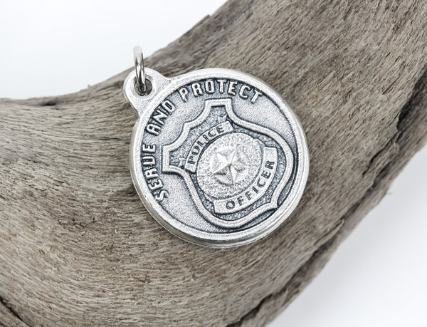 die cast silver medal depicting police badge protect serve