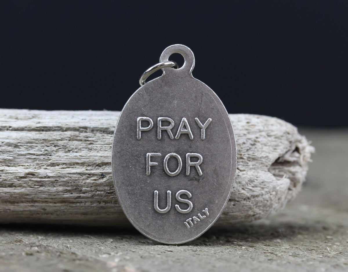 die cast silver medal inscribed with pray for us