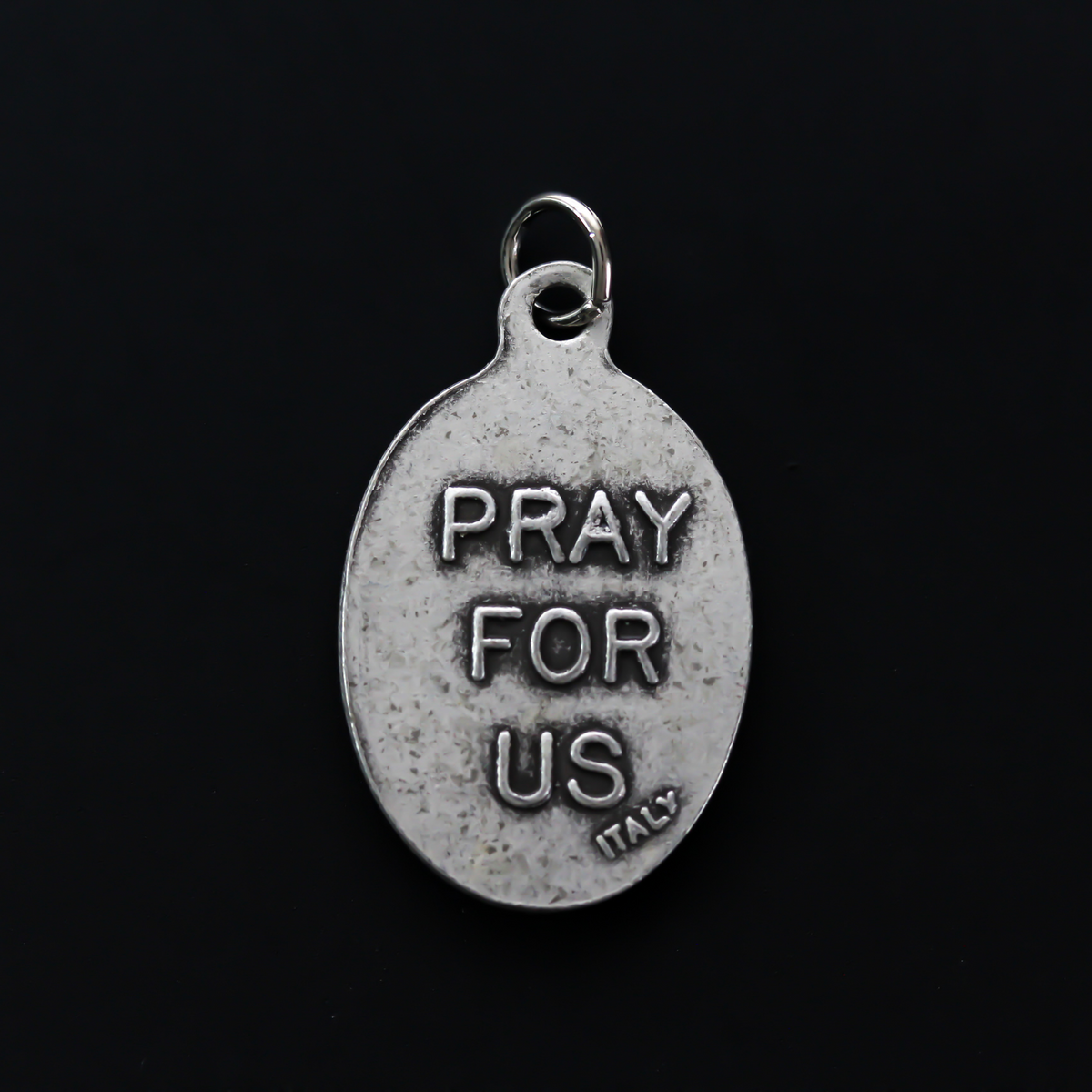 Santo Nino de Atocha medal that is marked "Pray For Us" on the reverse side