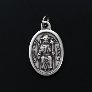 Santo Nino de Atocha medal that is marked "Pray For Us" on the reverse side