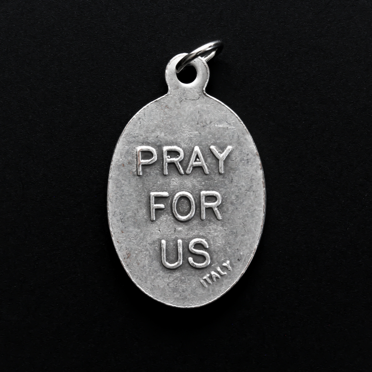 Infant Jesus of Prague medal that depicts the Infant Jesus on the front and is marked "Pray For Us" on the back