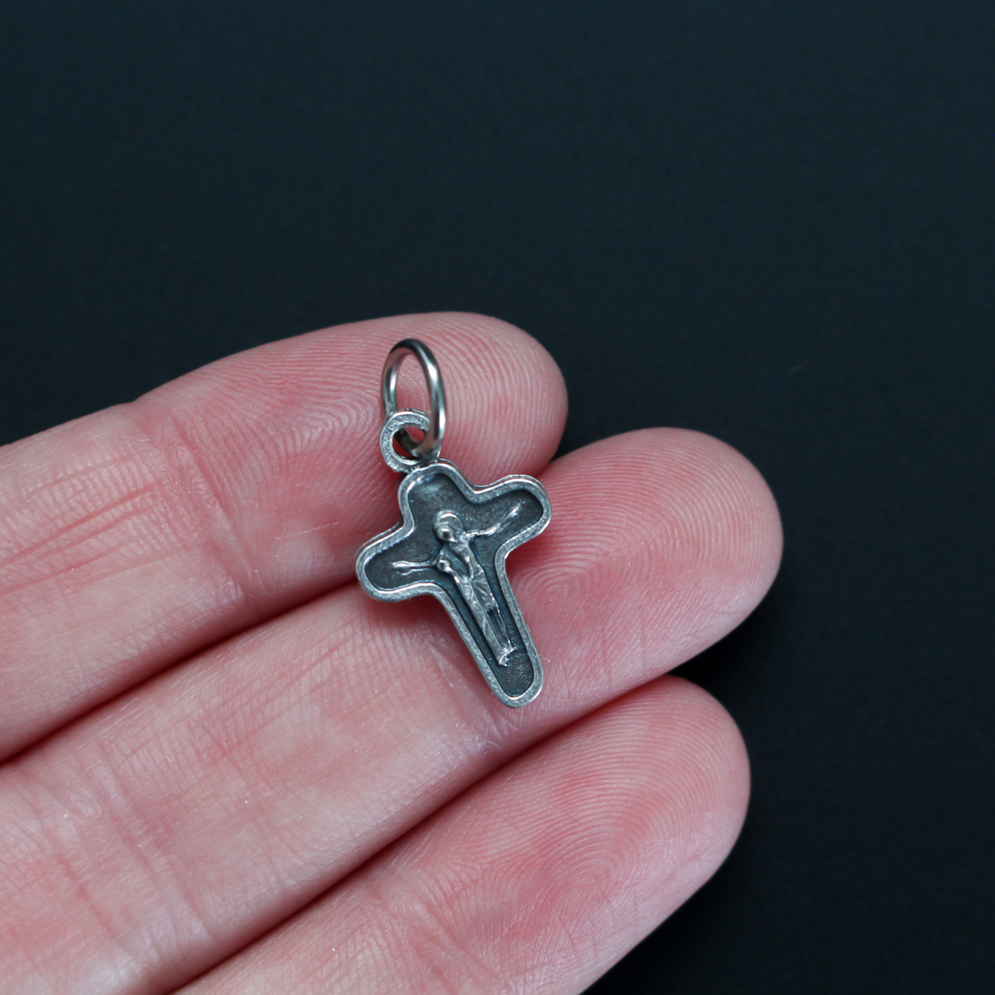 Small bracelet size Crucifixion pendant that depicts Mary at the side of Christ 3/4" long