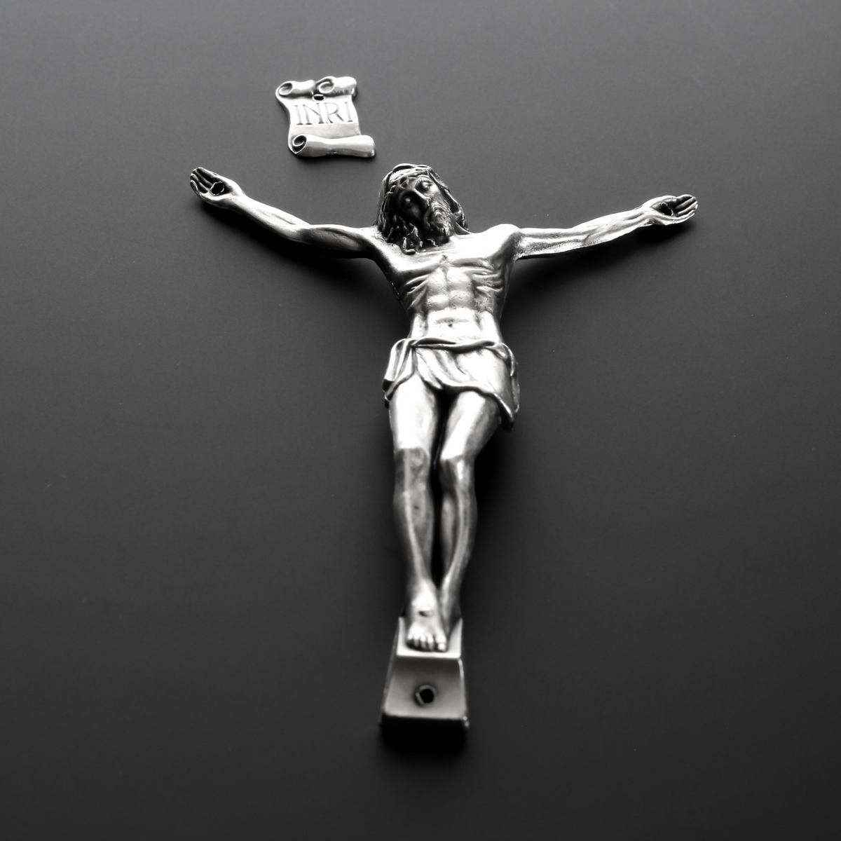4" corpus that comes with an INRI scroll that can be attached to a cross using the pre-drilled 2mm holes