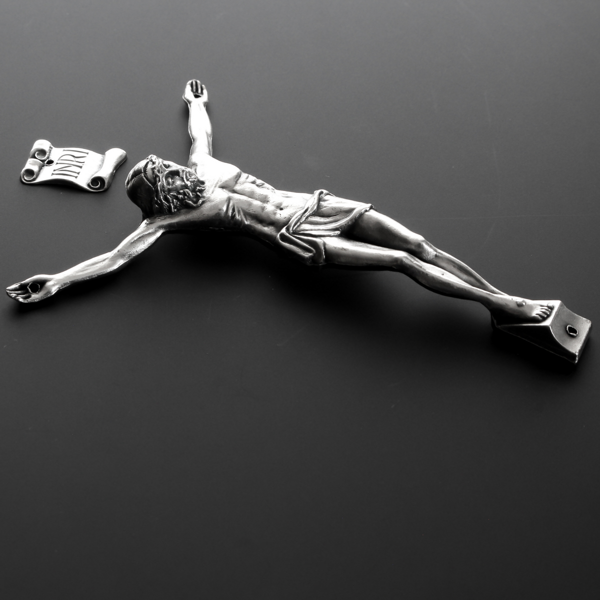 4" corpus that comes with an INRI scroll that can be attached to a cross using the pre-drilled 2mm holes