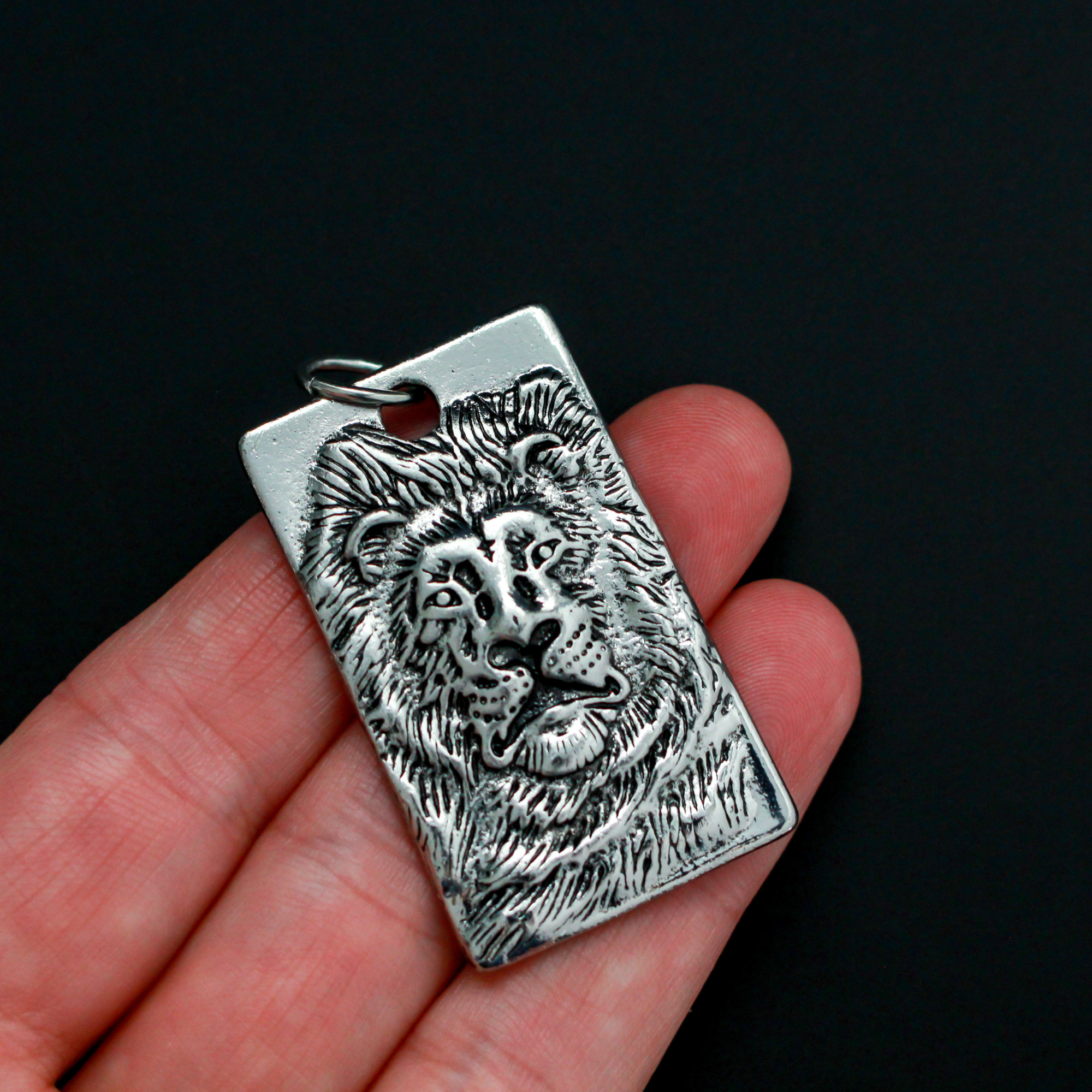 Large Rectangle pendant that depicts a 3D a lion face, 1.75 inches long