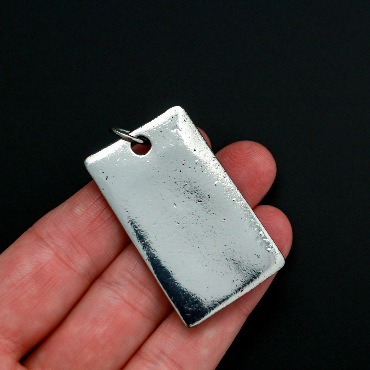 Large Rectangle pendant that depicts a 3D a lion face, 1.75 inches long