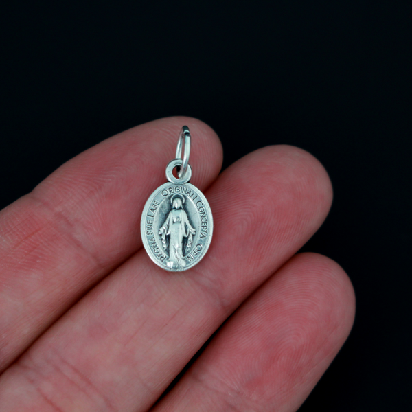 This is a small, beautifully detailed version of the Miraculous Medal in Latin. Measuring 1/2 inch in height