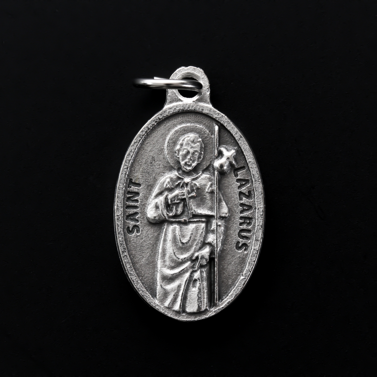 Saint Lazarus of Bethany oval medal that depicts the saint on the front and "Pray For Us" on the back.