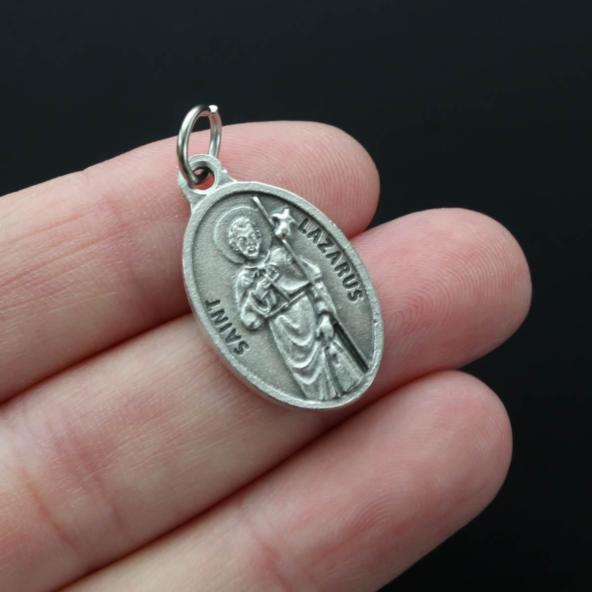 Saint Lazarus of Bethany oval medal that depicts the saint on the front and "Pray For Us" on the back.
