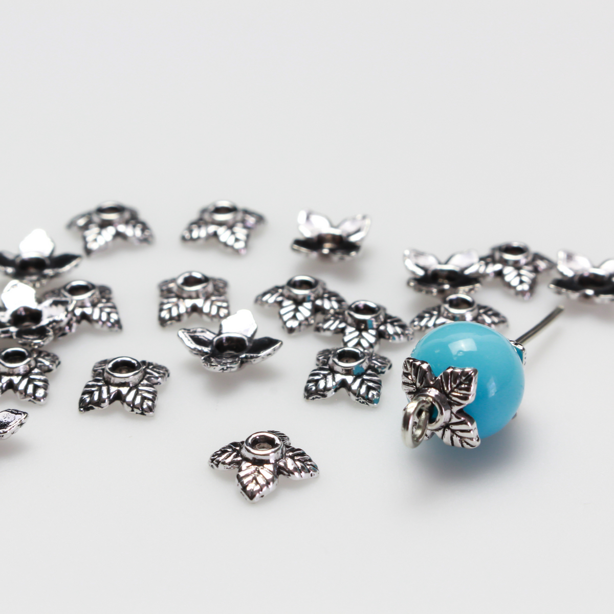 Leaf shaped bead caps with a four leaf pattern. They are 6mm with a 1mm hole