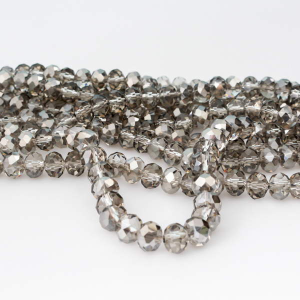 Light gray electroplate glass beads with a pearl luster plating. Rondelle in shape with a faceted design, 8x6mm
