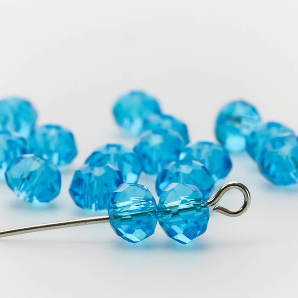 Asian cut crystal glass beads. 6mm x 4mm faceted light blue transparent. Sold in packages of 60 beads