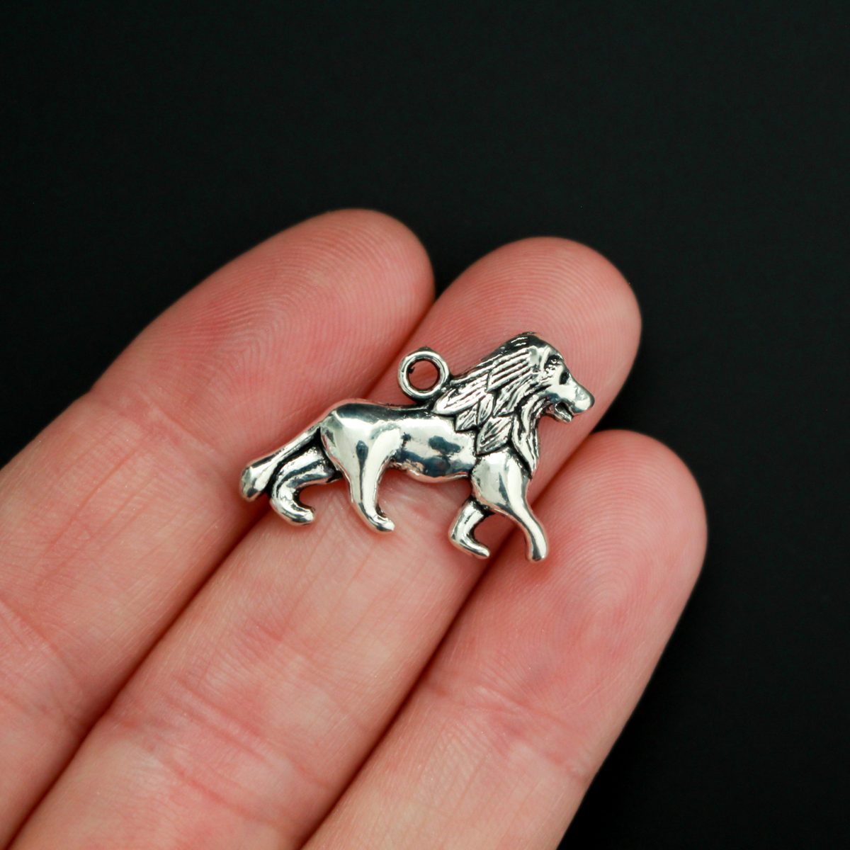 Lion charm in a silver-tone color, 16mm long