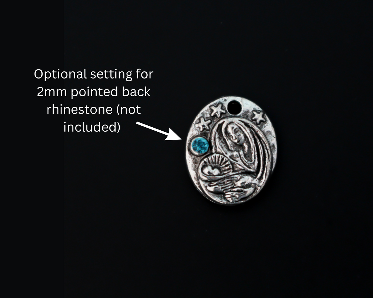 This dainty Madonna and child charm is crafted from quality metal and features a detailed design of the Virgin Mary holding infant Jesus