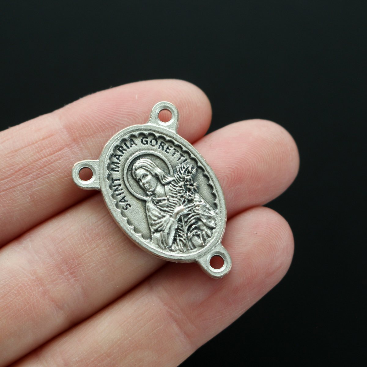 Saint Maria Goretti rosary centerpiece with a unique scalloped edge design.