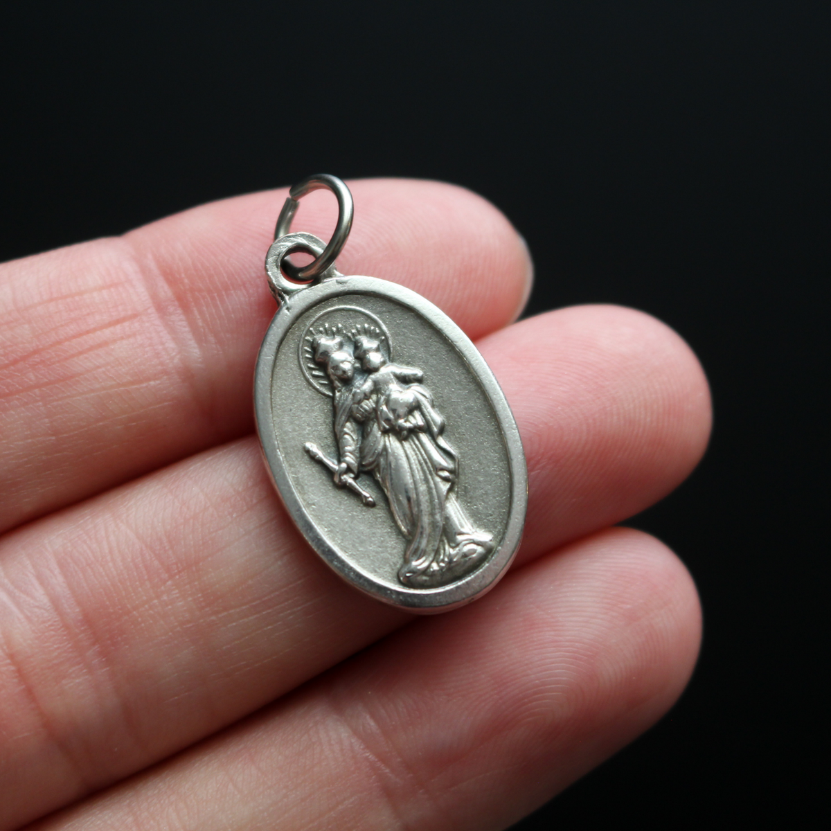 Mary Help of Christians oxidized medal has an image of the Blessed Virgin on the front and the words "Pray for Us" on the back