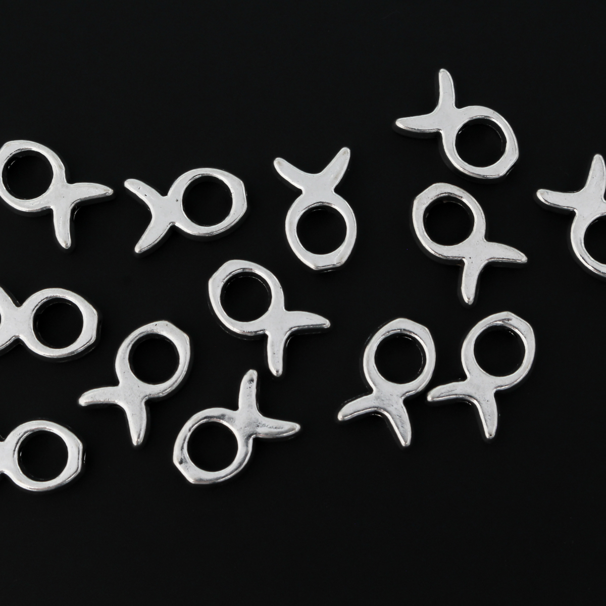 Silver tone bead frames that are shaped like a fish. They fit beads 4mm or smaller 
