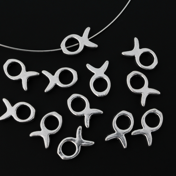 Silver tone bead frames that are shaped like a fish. They fit beads 4mm or smaller 