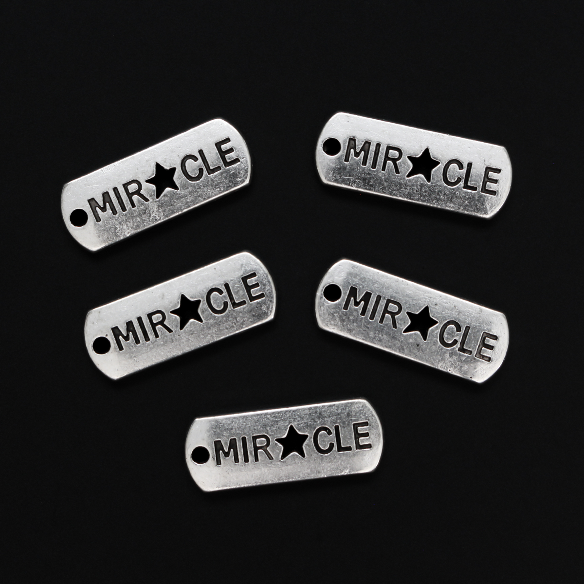 Rectangle antiqued silver-tone charms with an inspirational message of "MIRACLE" with a cut out star shape for the A