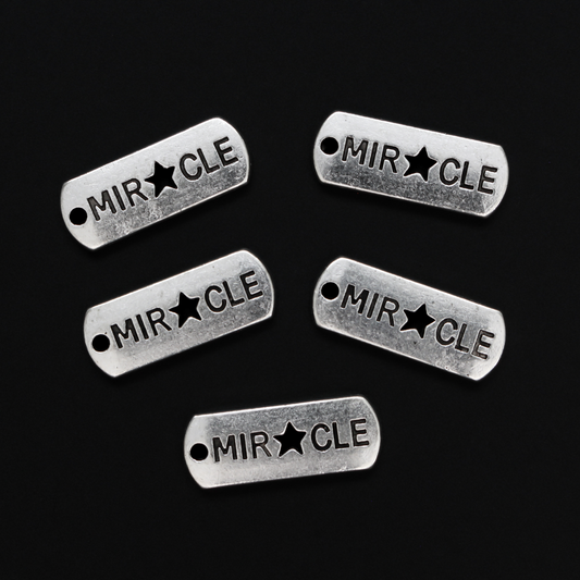 Rectangle antiqued silver-tone charms with an inspirational message of "MIRACLE" with a cut out star shape for the A